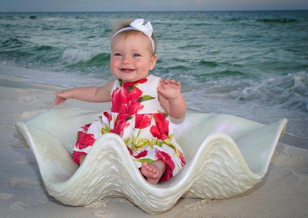 Adorable baby photo using shell prop at the beach