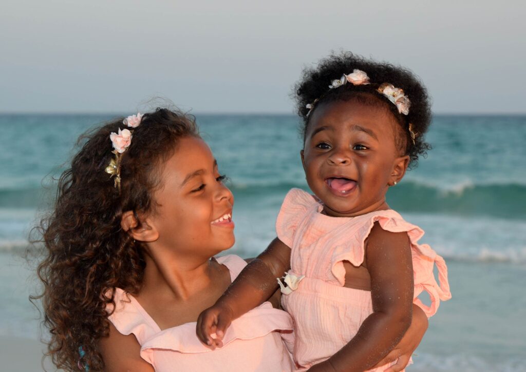 Kids in pretty spring dresses enjoying their beach photoshoot