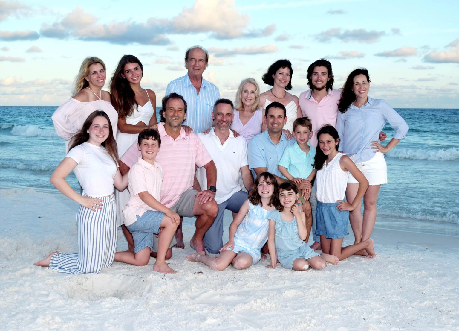 Family reunion portrait on the beach at sunset