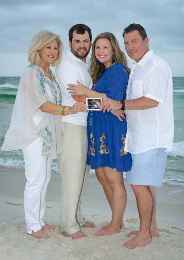 family on beach by maternity photographer