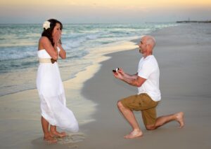 Man proposing at the beach captured by one of our Destin surprise proposal photographers.