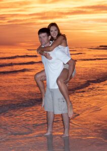 Young couple on Destin beach at sunset