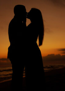 couple silhouetted in front of gorgeous Destin sunset