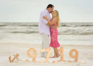 Beach engagement photo with date in foreground