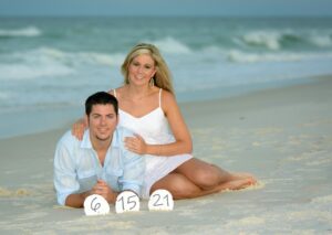 Couple on sand during sunset engagement photo shoot