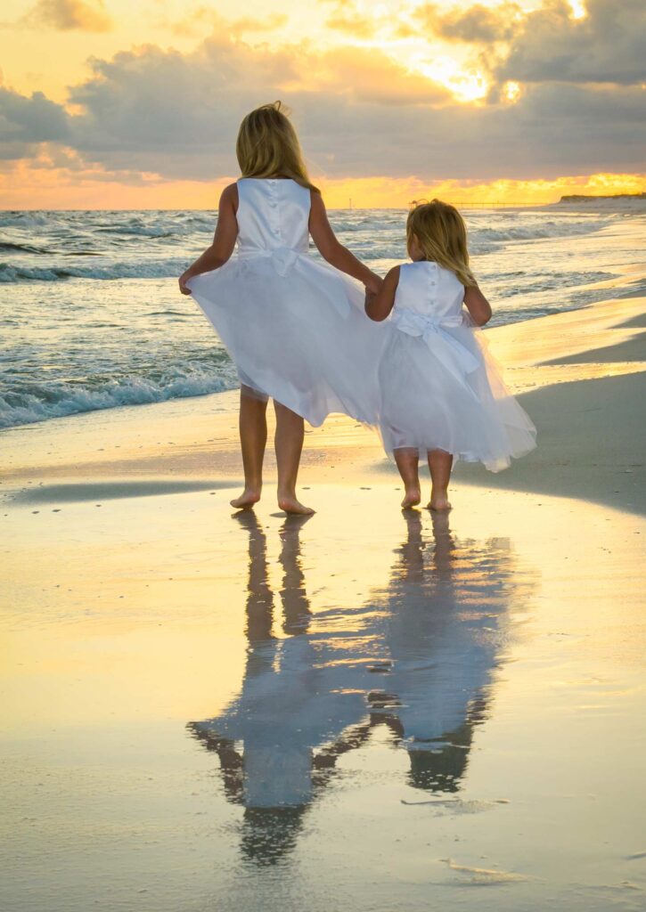 Cute kids on the beach at sunset