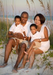 Family posing near sea oats for pictures