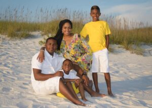 Family sunset photo with sea oats in the background