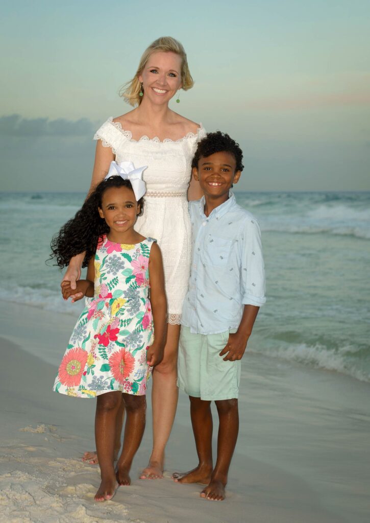 Family on the beach smiling for the camera