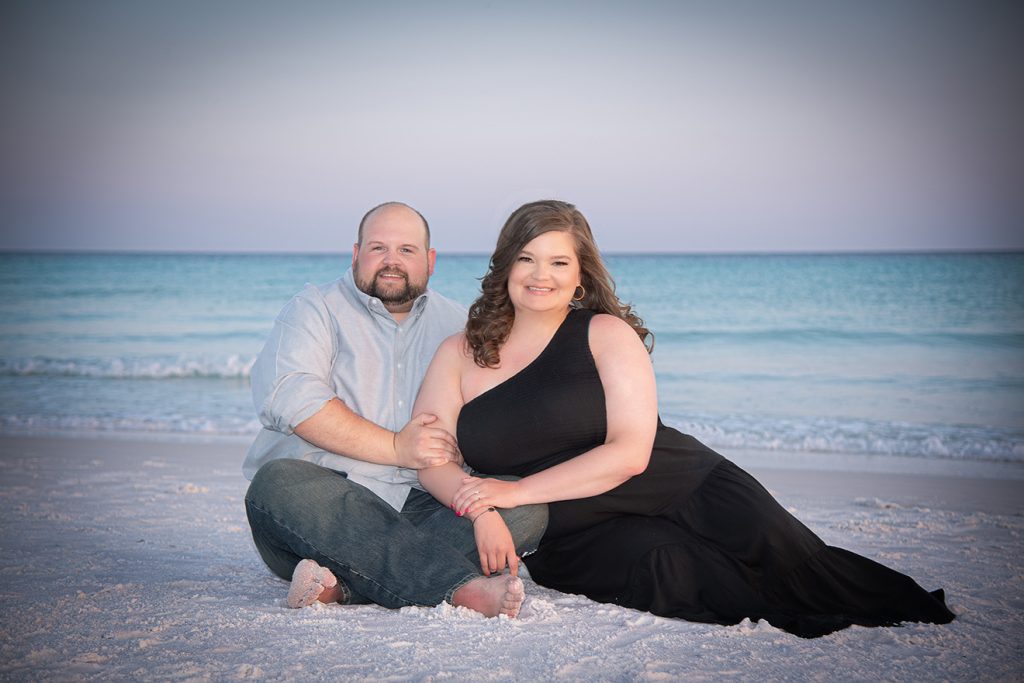 Couple sitting on beach.